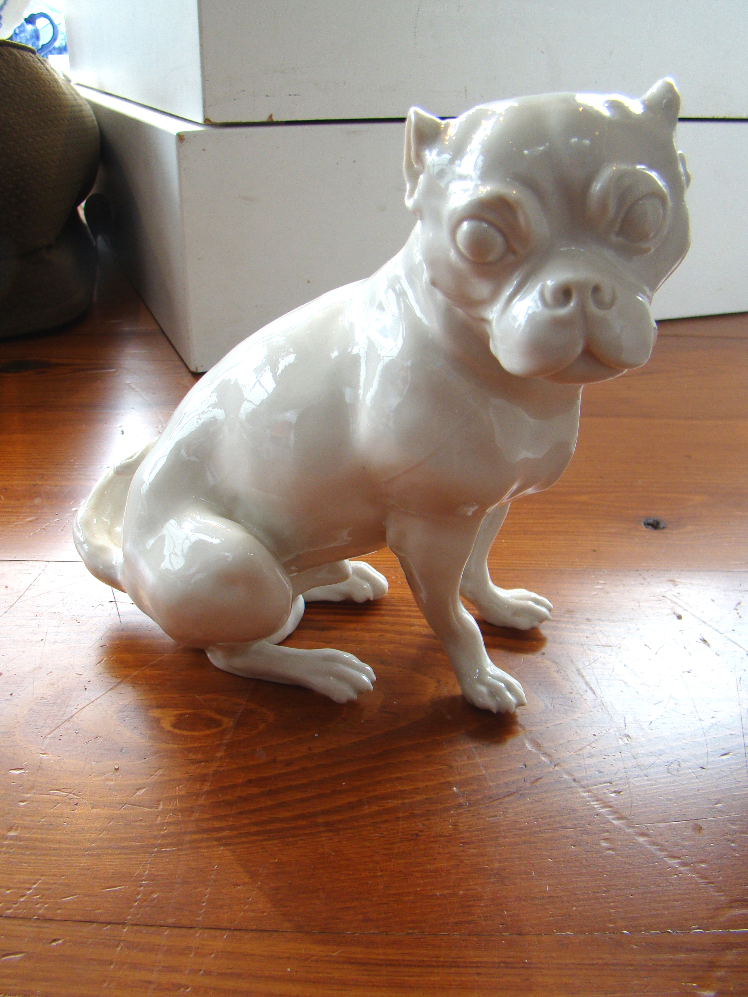 An attractive and rare late 18th/early 19th century Nymphenburg 'blanc de chine' pug dog