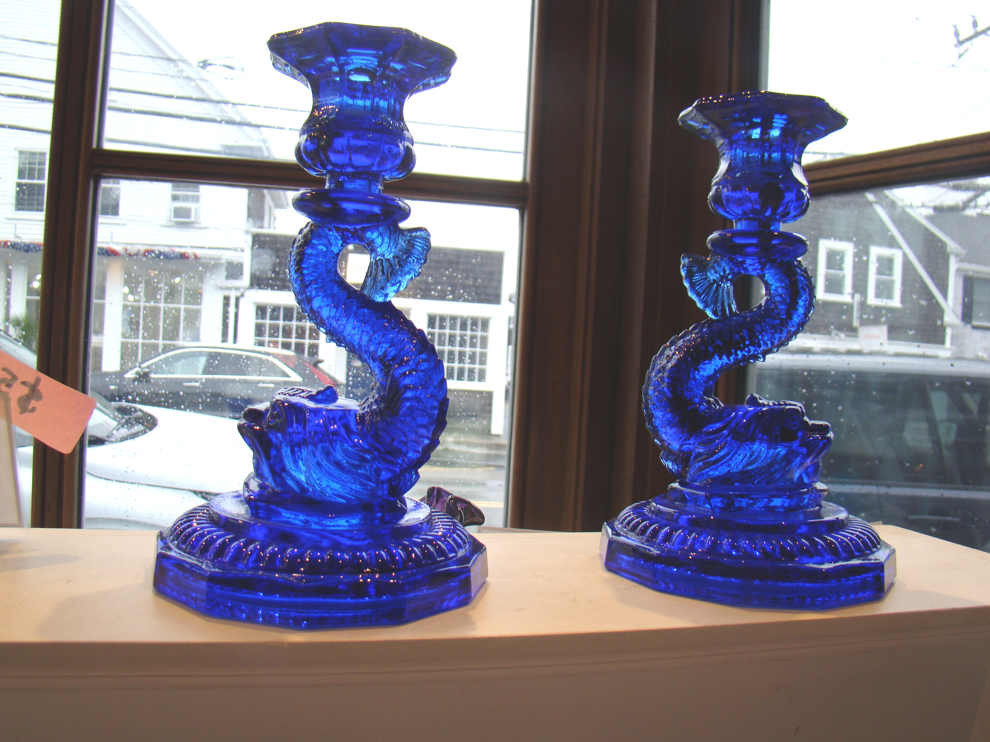 A stunning pair of vintage cobalt blue dolphin/coy candlesticks on double raised base