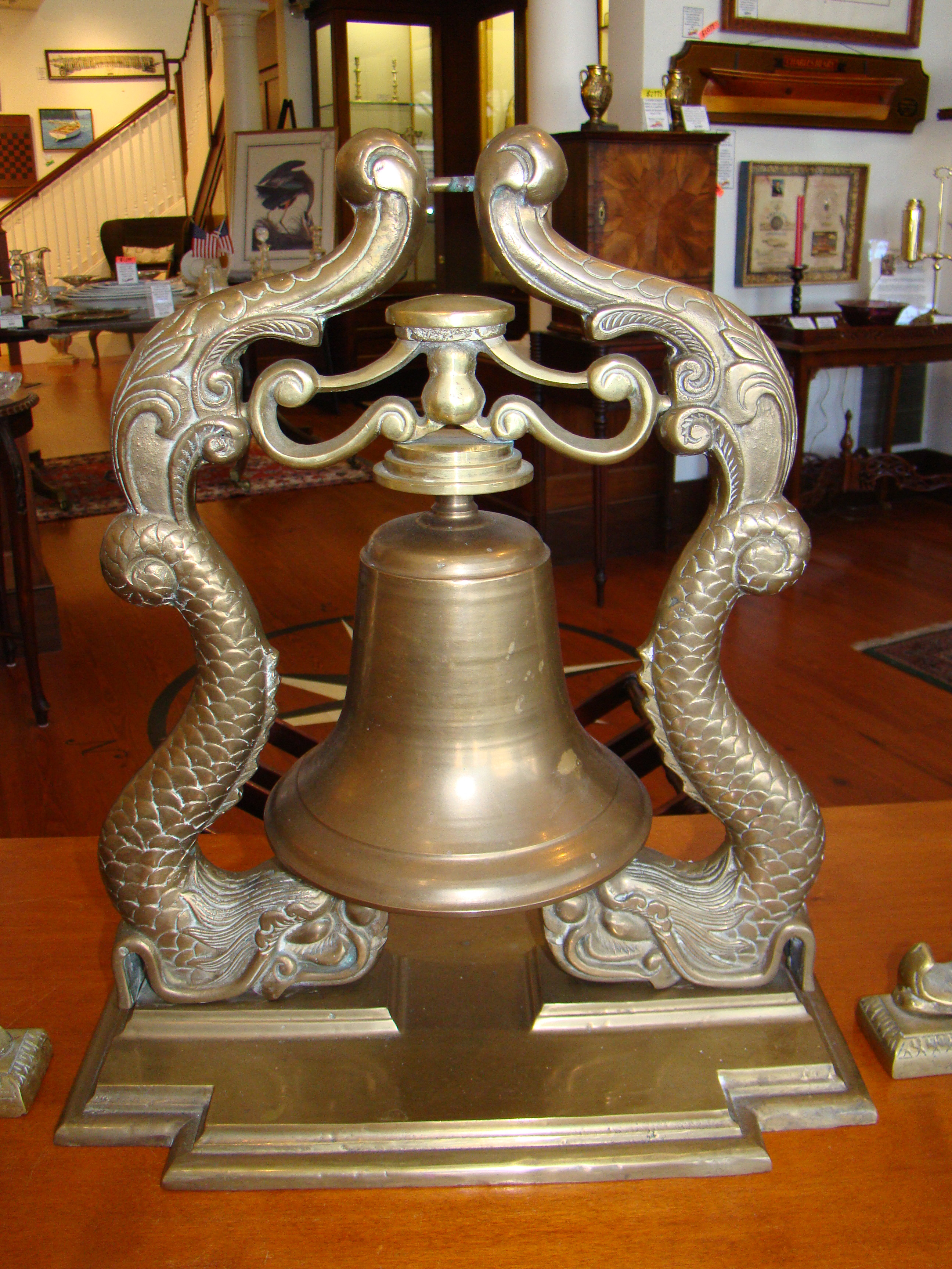 A fine ship's bell with dolphin supports