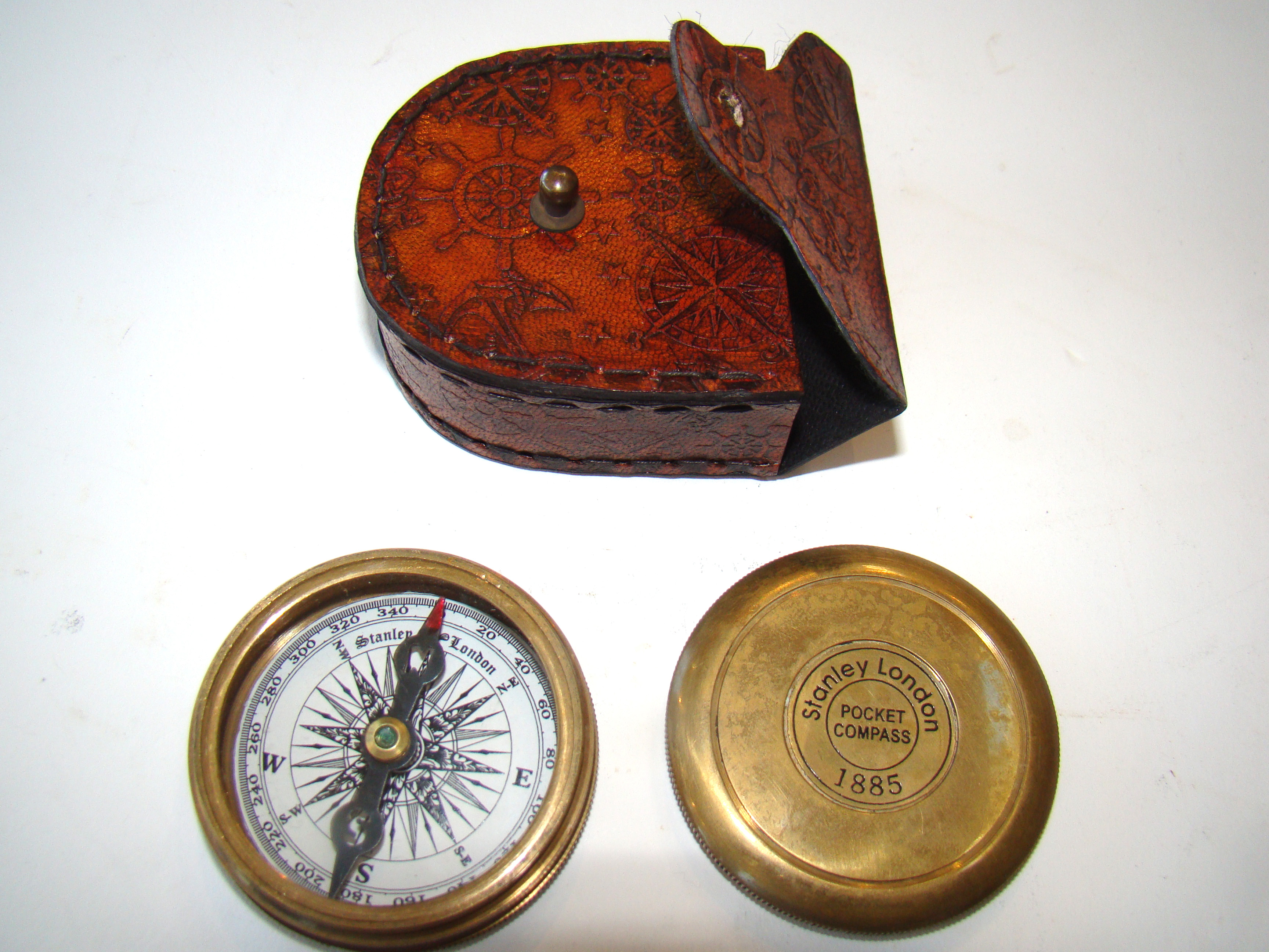 A fine vintage pocket compass with leather carrying case