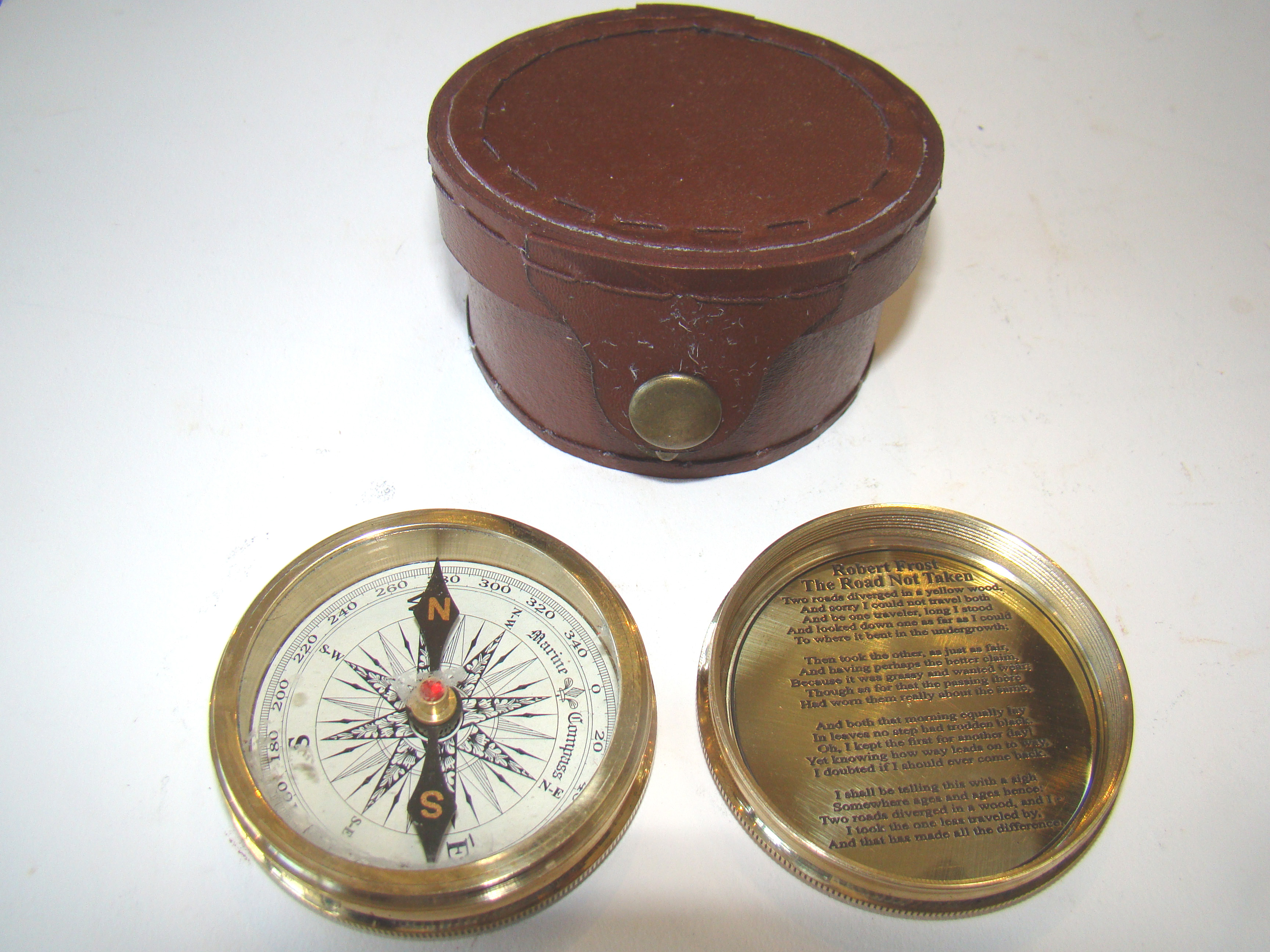 An attractive vintage pocket compass with leather carrying case