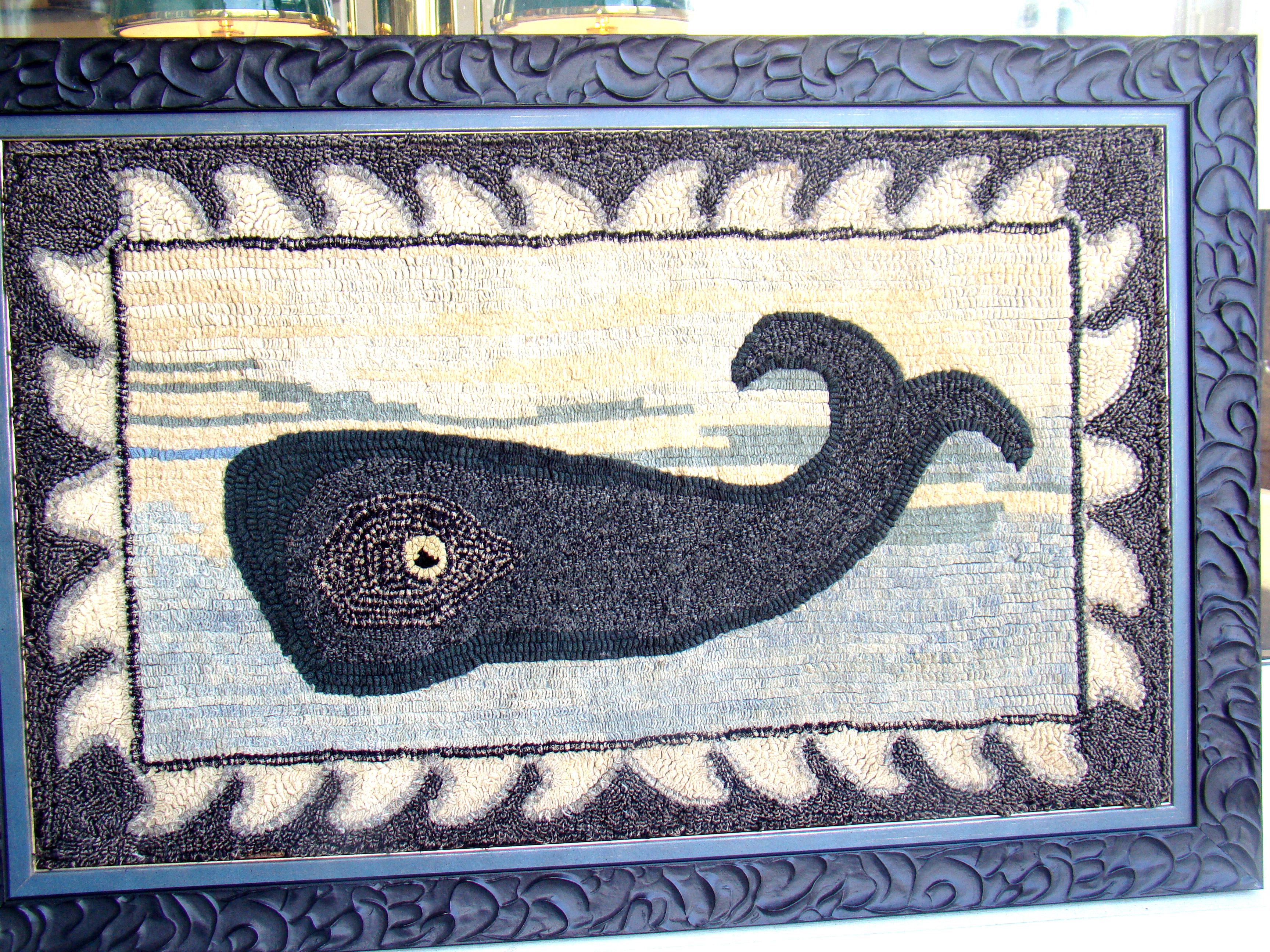 A fine antique (circa 1900) handmade hooked rug depicting a sperm whale from a New Bedford estate