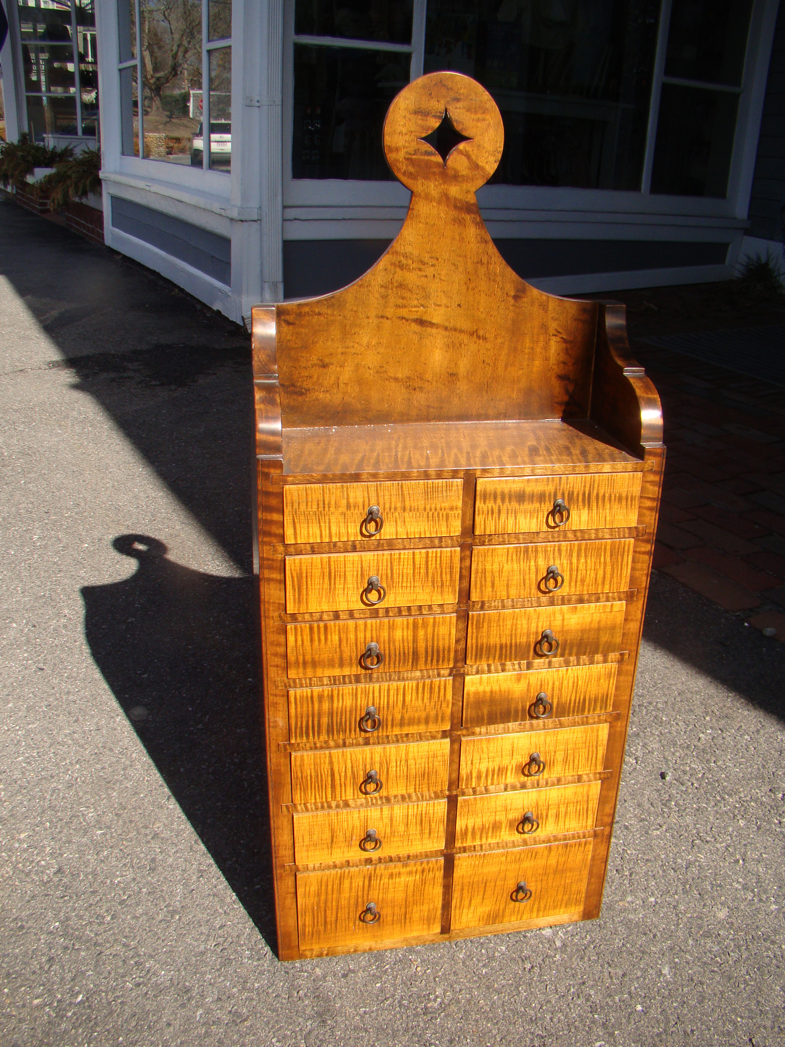 A STUNNUNG tiger maple spice box having 14 drawers, 20th century