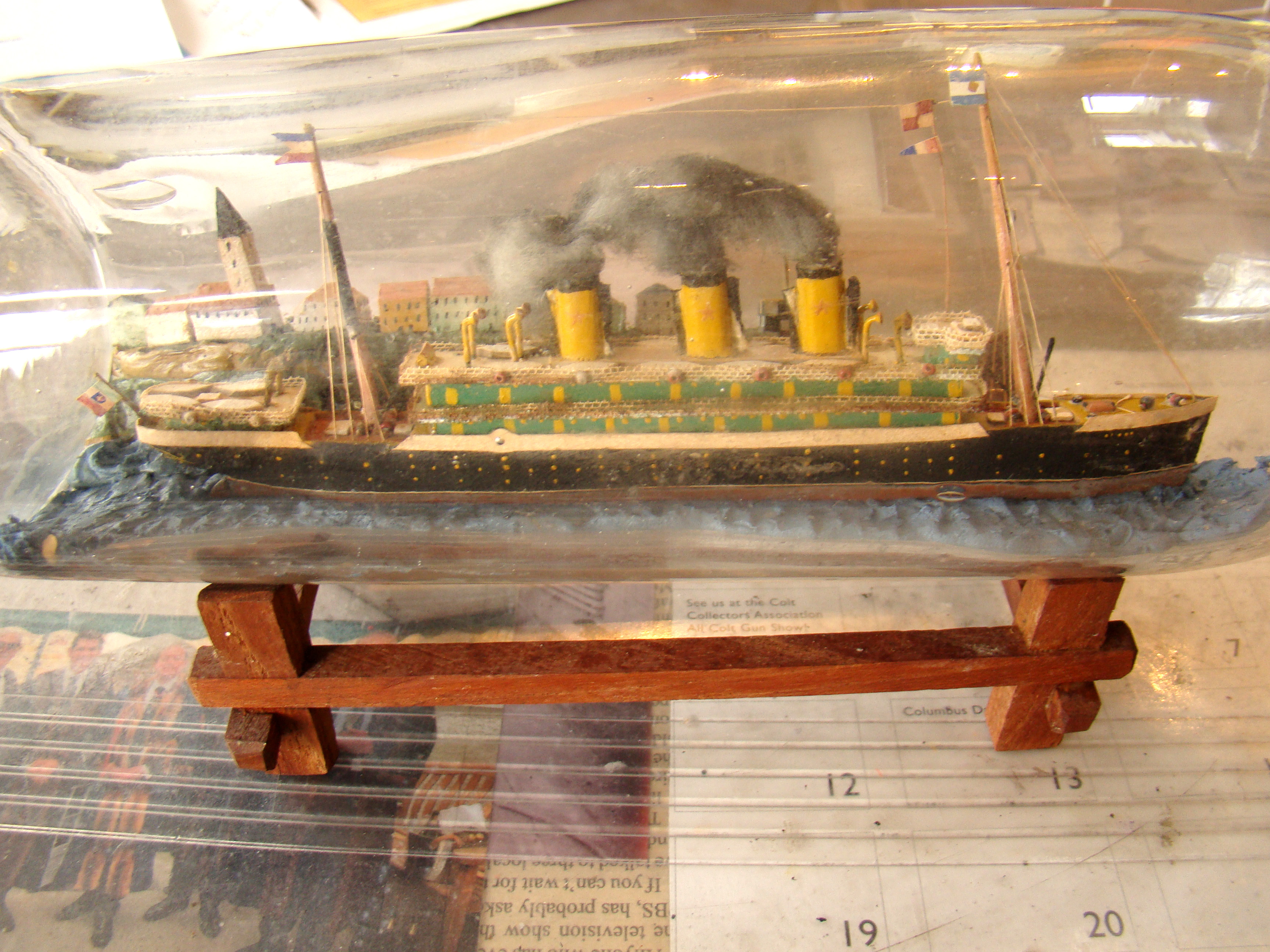 A fine antique three-funneled passenger liner ship-in-a bottle circa 1910