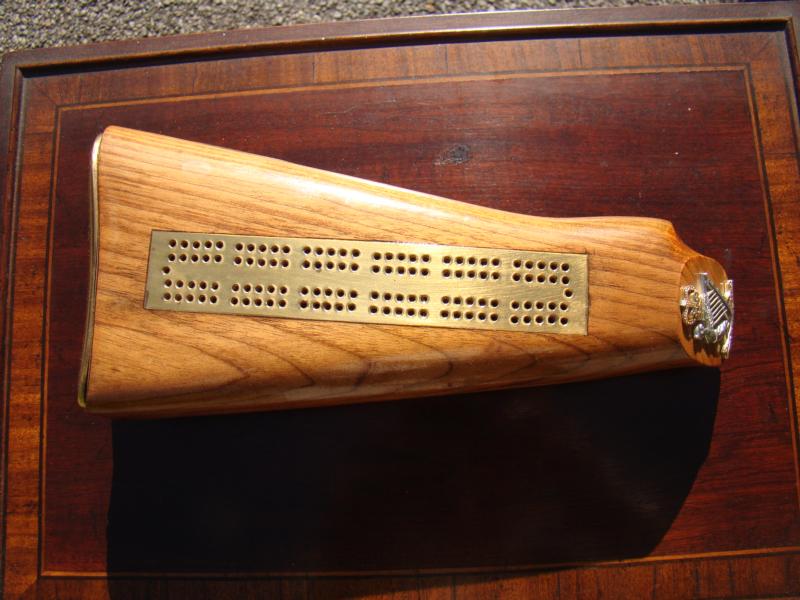 A late 19th/early 20th century rifle butt converted into a cribbage board