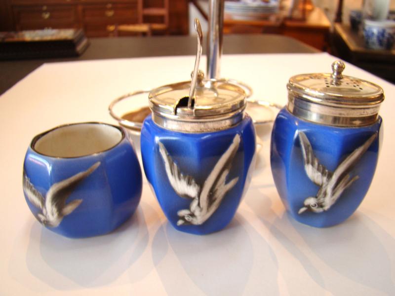 A vintage three-piece condiment set featuring three porcelain pieces painted with birds