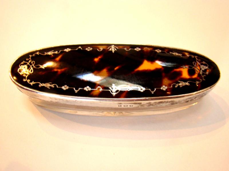 A late 19th century tortoiseshell and silver lidded jewelry box