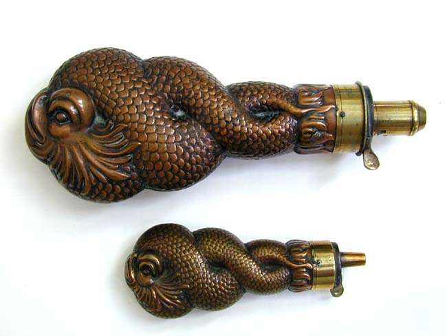 A Fine Pair of Copper Entwined Dolphin Form Powder Flasks circa 1850.