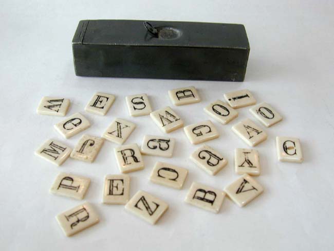 A 19th Century Whalebone Alphabet Set in a 19th Century Pewter Apothecary Container.
